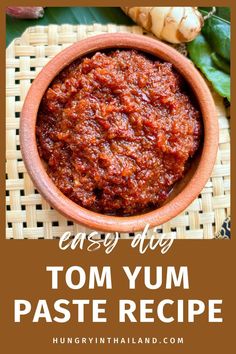 a bowl filled with tomato paste and basil leaves