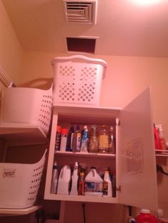 the inside of a small kitchen cabinet with lots of bottles and containers on top of it