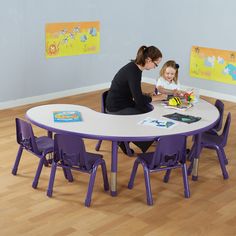 an adult and child sitting at a table with purple chairs in front of them on the floor