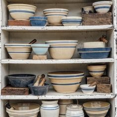 shelves filled with bowls and containers on top of each other