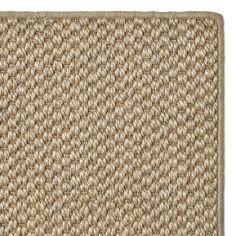 a close up view of a beige area rug