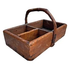 an old wooden box with a handle on the top and two compartments below it that are empty