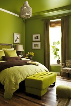 a bedroom with green walls and wood flooring in the room is furnished with an ottoman