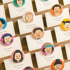 a bunch of buttons with people on them sitting next to each other in front of some cards