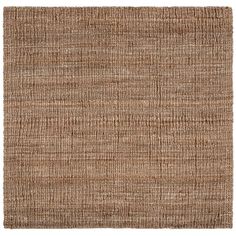 an area rug made out of jute and woven in various shades of brown, with a white background