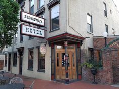 the entrance to bradaway hotel with tables and chairs outside