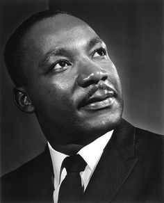 a black and white photo of a man in a suit looking off to the side