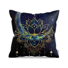 a decorative pillow with a blue flower and crescent moon on the front, against a white background