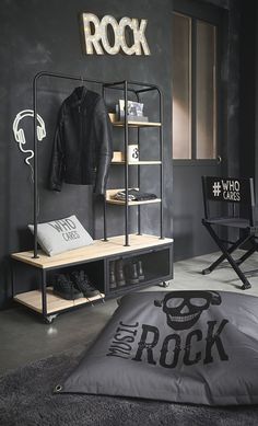 a black and white bedroom with a rock sign on the wall