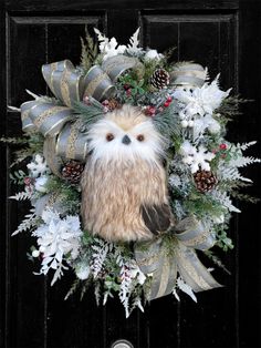 a wreath with an owl and pine cones on it