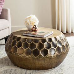 a gold coffee table with flowers on top