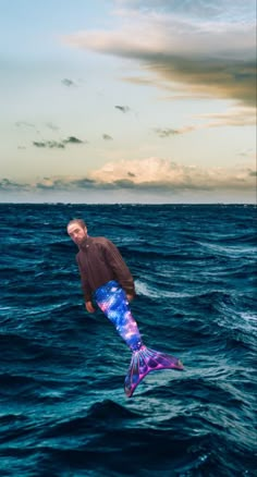 a man is in the air with a kite above the water while standing on his surfboard