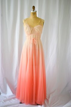 1950s Nightgown | Vanity Fair | Vintage 50s Sunset Ombre Nylon Chiffon Nightgown Full Length Grecian Braids and Tie Gold Conversation Label DETAILS: *1950s era *Salmon pink or sunset ombre nylon chiffon - double layer (semi sheer) *Grecian goddess details- braided spaghetti straps and waist tie *Cross over bodice *Empire waist *Gathered skirt *Full length *Absolutely stunning! LABEL: Vanity Fair - gold label also known as Conversation label. CONDITION: Excellent MEASUREMENTS:  Bust= 32" Empire Waist / under bust= 28" Hip= Free High Point Shoulder to hem= 55" Compare with your own measurements + ease or compare with similar garments in your closet. SHIPPING: This item will ship via priority mail domestically and internationally.  NOTE: ALL SALES ARE FINAL. Items are freshly cleaned and read 1950s Nightgown, Grecian Goddess, Women's Nightgowns, Gathered Skirt, Pink Ombre, Empire Waist, Vanity Fair, Historical Fashion, Night Gown