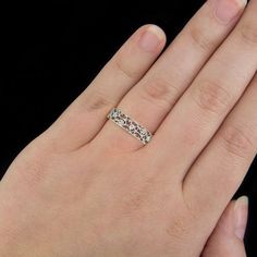 a woman's hand with a wedding ring on top of her finger, showing the band