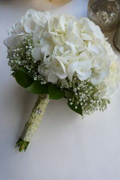 a bouquet of white flowers sitting on top of a table