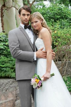 a bride and groom pose for a wedding photo