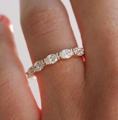 a woman's hand with a diamond ring on it