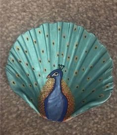 a paper fan with a peacock painted on it