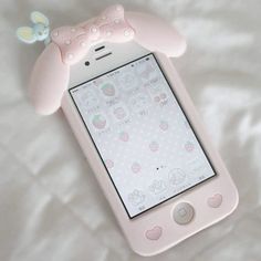 a pink cell phone laying on top of a white sheet