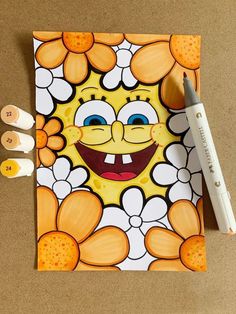 an image of a cartoon character on a piece of paper next to markers and pencils