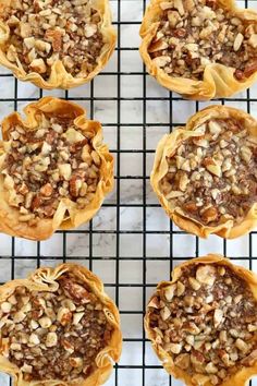 six pies on a cooling rack ready to be baked in the oven for dessert