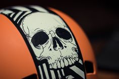 an orange helmet with a skull painted on it