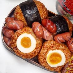 a plate with sausages, eggs and rice on it