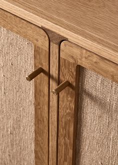 a close up view of a wooden cabinet with two handles on it's sides