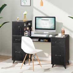 a desk with a computer on top of it and a chair in front of it