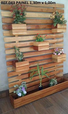 wooden planters are arranged on the side of a wall