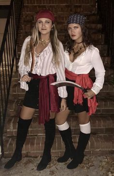 two women dressed in pirate costumes standing next to each other