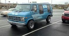 two cars are parked in a parking lot next to each other and one is blue