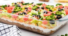 a casserole dish filled with vegetables and black olives