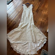 a white dress sitting on top of a wooden floor