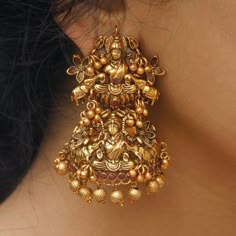 Amazing Temple Laxmi Goddess Statue With Studded Ruby Stone, Antique Delicate Earring with Gold Plating Features Suitable for All Occasions & Indian Attire Traditional Earrings With Metal Carving Handwork Perfect For Indian Weddings And Celebrations Length: Approx. 6.6 Cms x Width 3.8 Cms Material - Brass Plating - Gold Gemstone: Ruby Closure: Pushback Packaging Promise - Customer satisfaction is our extensive priority. -- Our products are (QC) quality checked --- Double Bubble Wrapped packe Temple Jhumkas Earrings, South Indian Earrings, Laxmi Goddess, Temple Indian, Unique Wedding Earrings, Oxidised Jewelry, Earring Indian, Temple Jewellery Earrings, Goddess Earrings