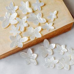 These mother of pearl flowers are delicate and beautiful at quite unique shapes, perfect to be used in earring, headwear or ring design. Size: approx 2-4mm thick, 20-45mm size, I divide them into 3 sizes. size S: 20-30mm, mainly 25mm approx. size M: 32-38mm, mainly 35mm approx. size L: 40-45mm, mainly 42mm approx. Quantity: 5pcs Material: natural white mother of pearl You can leave a message to me saying you want the larger or smaller ones. ❤ Pictures are taken under afternoon natural sunlight❤ White Shell For Wedding, White Mother Of Pearl Shell For Wedding, White Handmade Shell For Wedding, Carved Flowers, Shell Flowers, Pearl Flowers, Unique Shapes, Carved Shell, Pearl Design