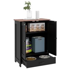 an open cabinet with food and drinks on the top shelf next to a potted plant