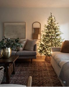 a living room filled with furniture and a christmas tree in the middle of the room