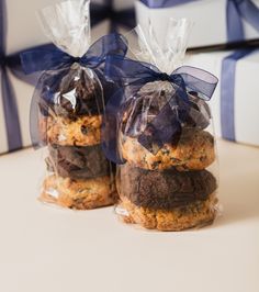 three cookies wrapped in plastic and tied with blue ribbon