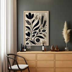 a black and white painting on the wall above a dresser