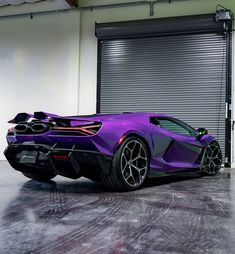 a purple sports car parked in front of a garage door