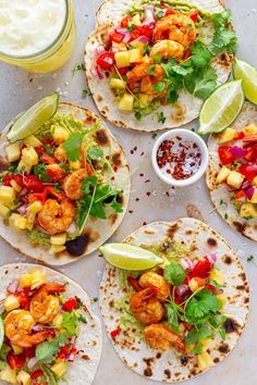 four tortillas filled with shrimp, pineapple salsa and avocado garnished with cilantro