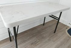 a white table sitting on top of a hard wood floor