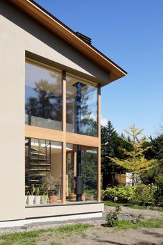 an exterior view of a modern house with large windows