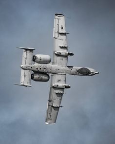 an airplane is flying in the sky on a cloudy day