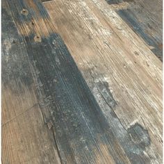 an old wooden floor with peeling paint on it