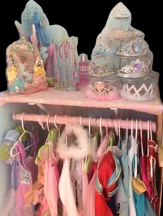 a toy closet filled with lots of different types of clothing and accessories on hangers