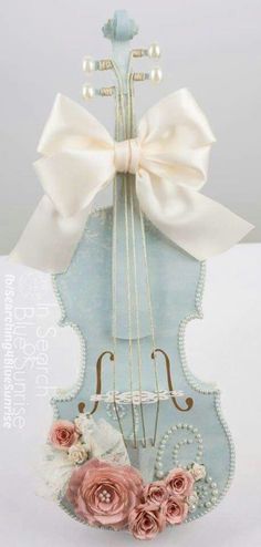 a violin with a bow and flowers on it