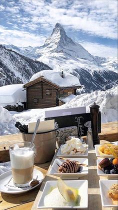 a table topped with plates of food covered in snow