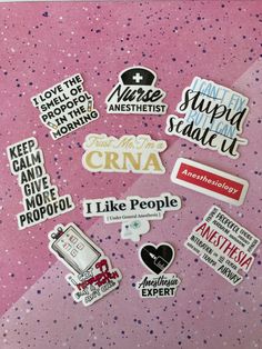 various stickers are placed on a pink surface